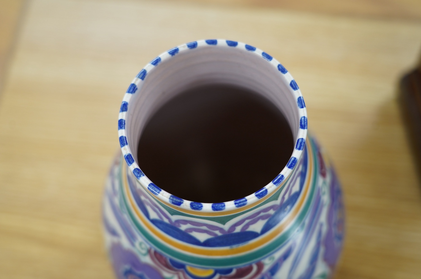 A 1930’s Poole pottery vase and a later mug, vase 25cm high. Condition - fair slight grazing to base rim of vase